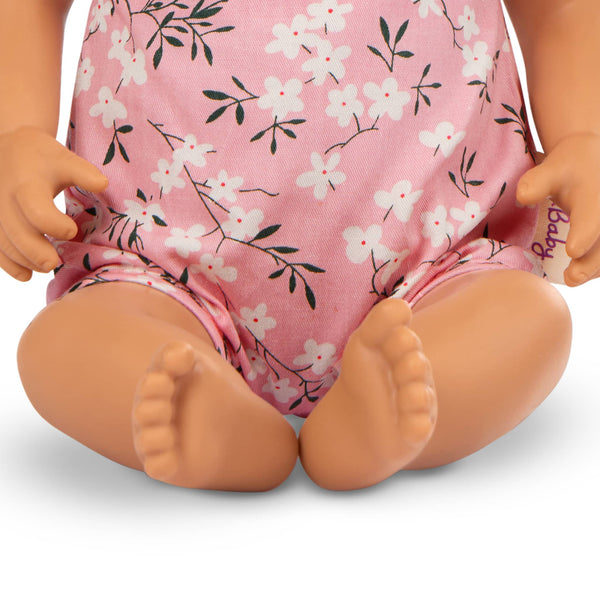 Babypuppe mit Schnuller – In rosa Kleidchen mit Blümchenmuster und Haarband