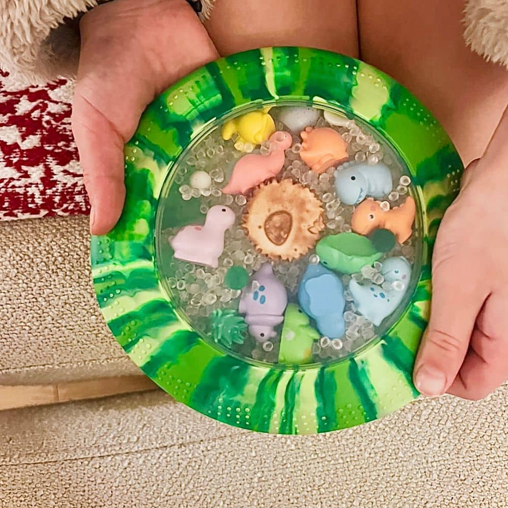 Peekaboo-Sensorikscheibe mit Figuren - Dinosaurier