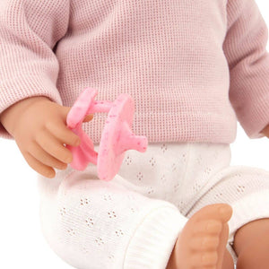 Babypuppe mit Haaren und Schnuller, in einem zweiteiligen Outfit