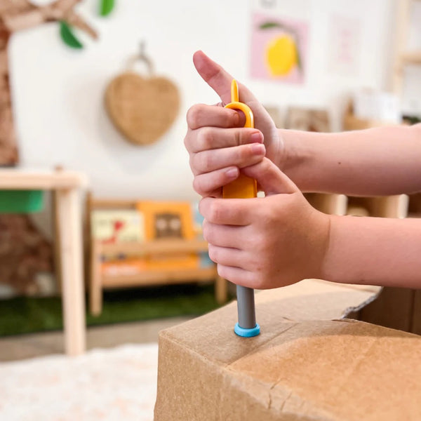 Kinderhände benutzen Schraubenzieher aus dem Schraubensatz für DIY-Konstruktionen – SCRU COMBO 160 Teile von Makedo
