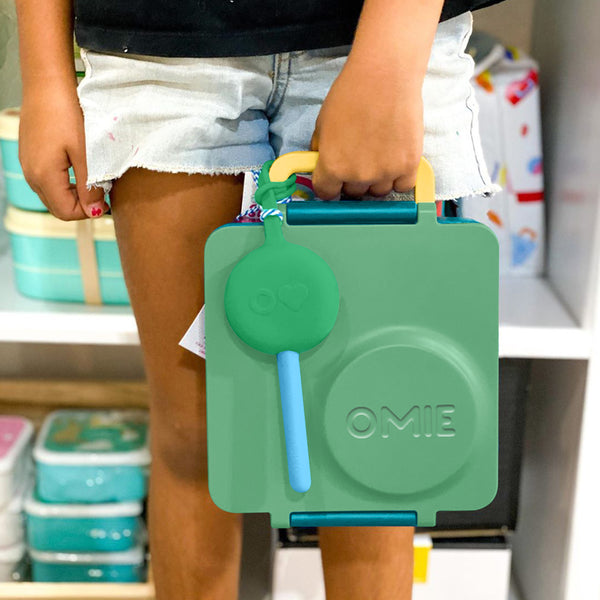 Lunchbox mit Thermoskanne OmieBox – Meadow in grün gehalten mit gelbem Griff, von Kind gehalten