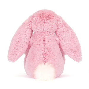 Rückansicht von einem Plüschkaninchen LUX mit Blumenöhrchen in Rosa, perfekt zum Kuscheln.