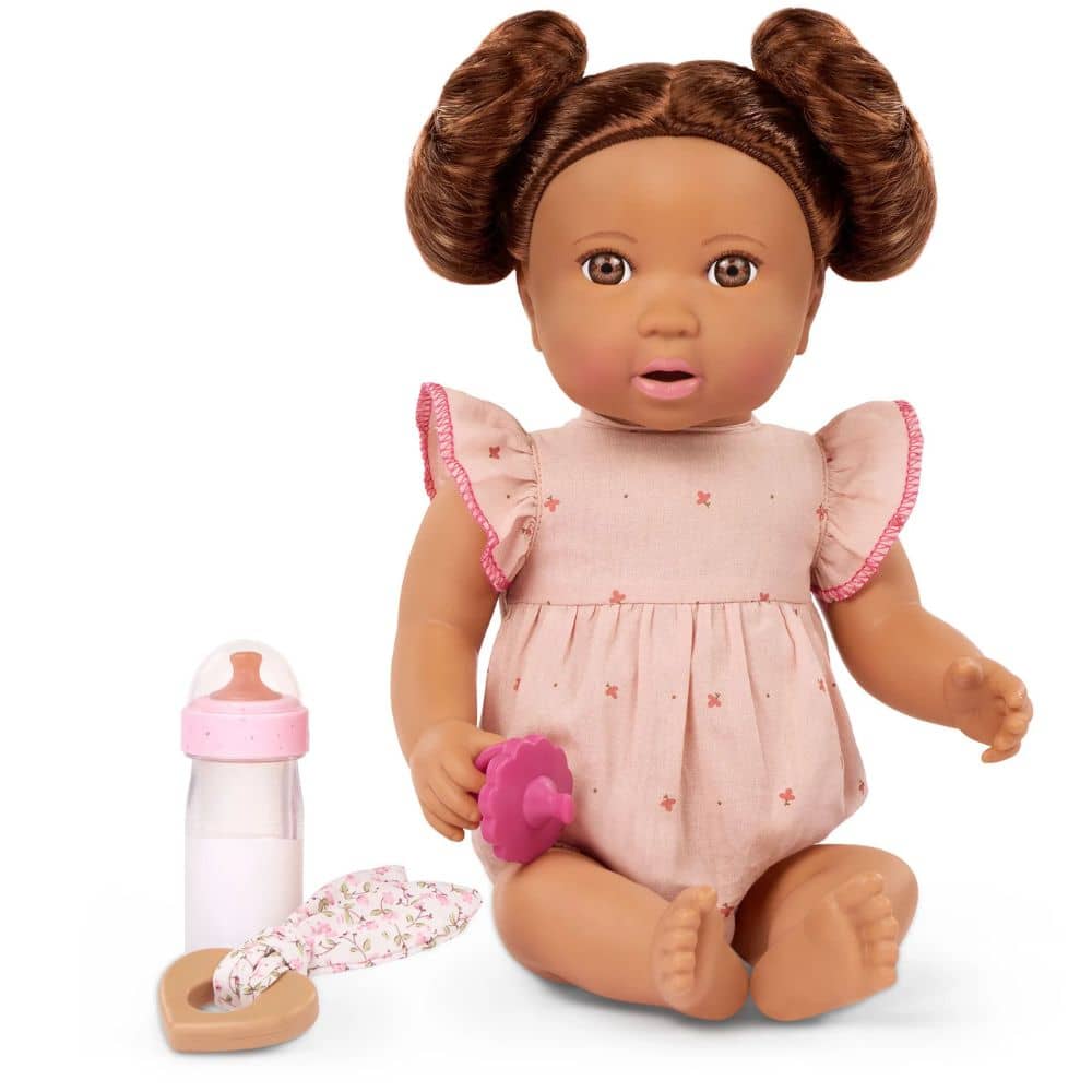 Babypuppe mit Haaren und einer Flasche mit Milcheffekt